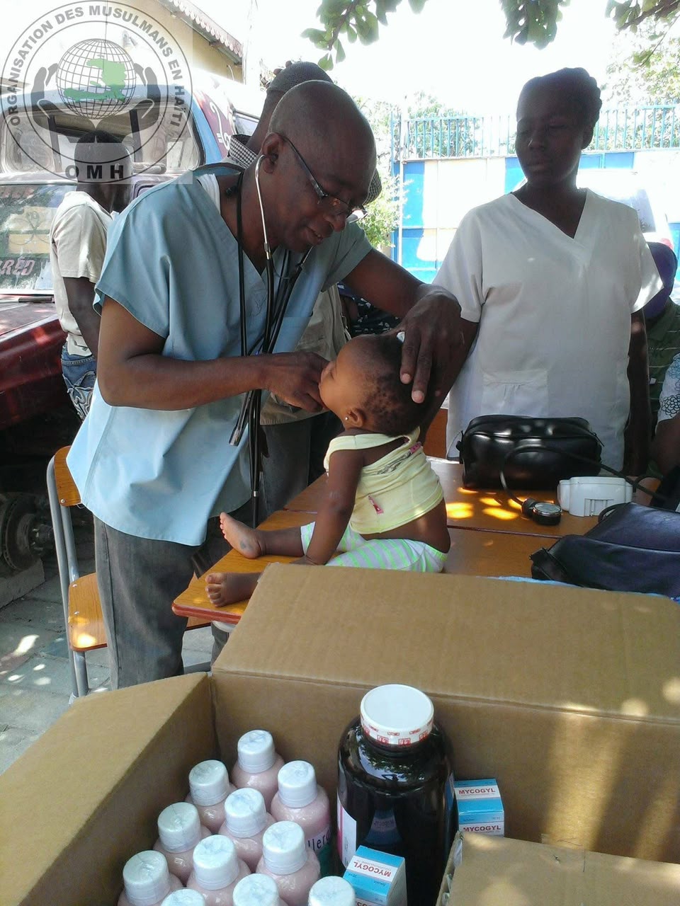 A doctor gently examines a baby at our mobile clinic.